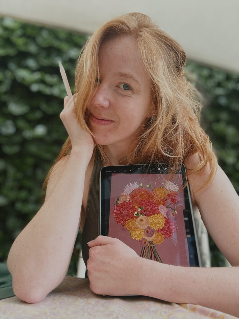 Woman holding an ipad and pencil, drawing flowers.