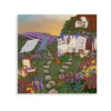 A garden in summer showing fresh laundry hanging and lavender fields in the background.
